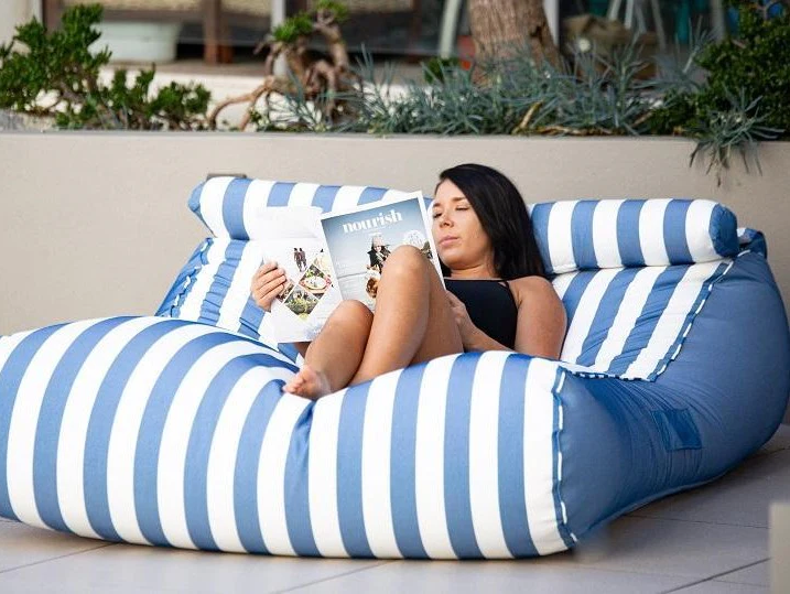 Woman relaxing on a comfortable giant bean bag
