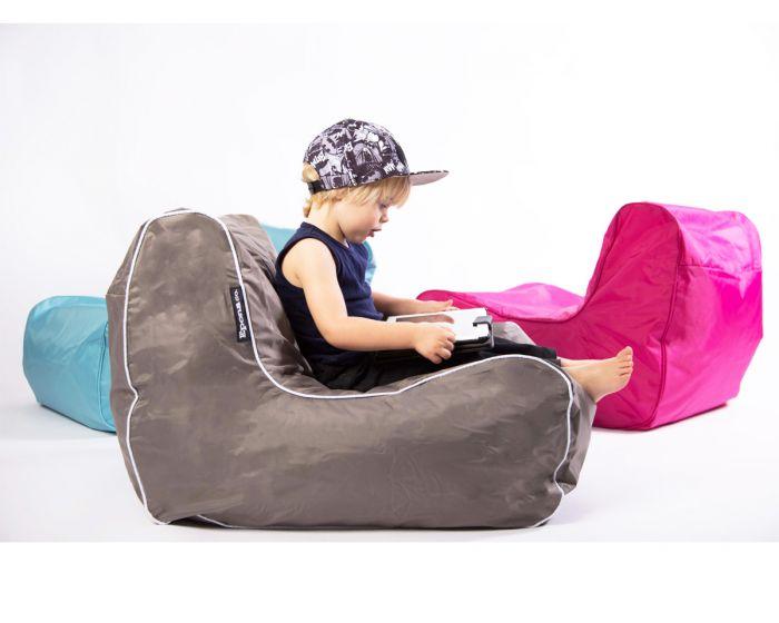 Boy sitting on bean bag with tablet