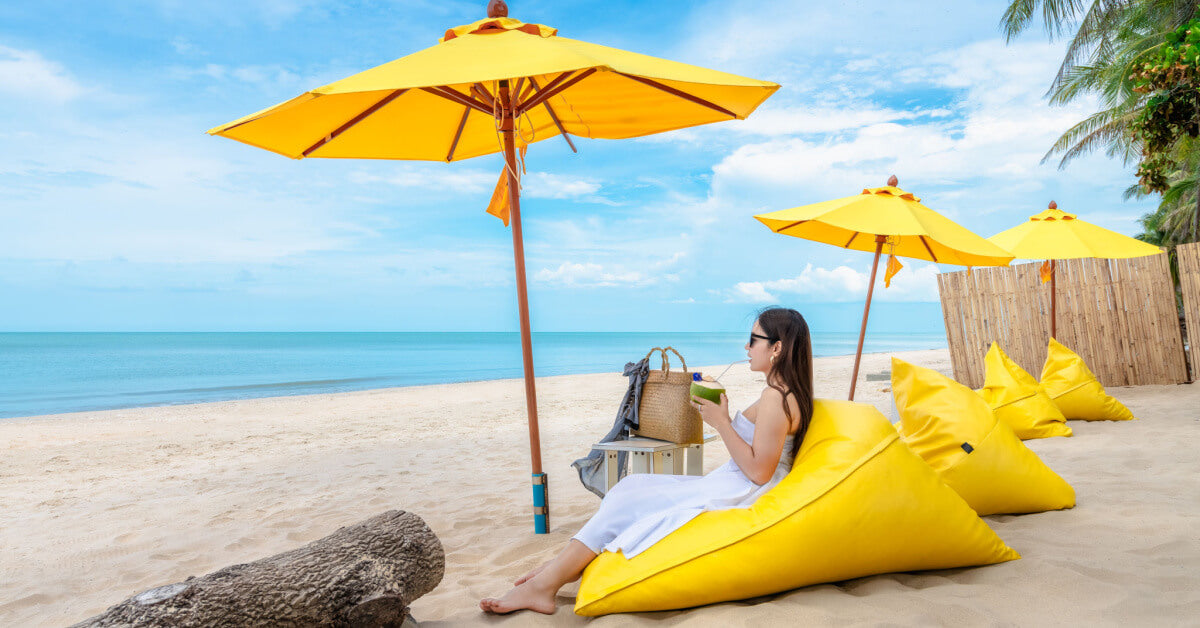 Summer lifestyle, tourist relaxing on bean bag chair on beach